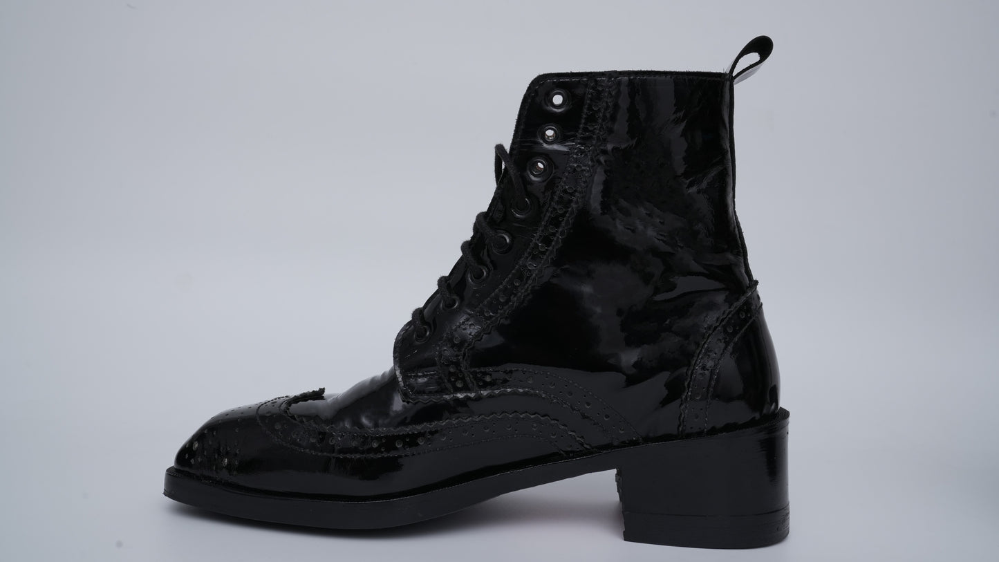 Black lace-up boot on a gray background